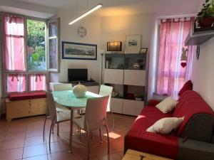 a living room with a red couch and a table at VECCHIA STAZIONE - by Satisfactual Property in Menaggio