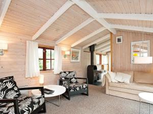 a living room with a couch and chairs at 6 person holiday home in Dannemare in Dannemare +31 photos