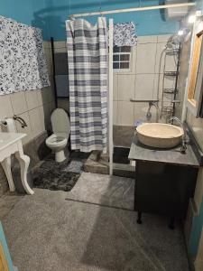 a bathroom with a sink and a toilet and a shower at ALMOND Cove in Grand Case