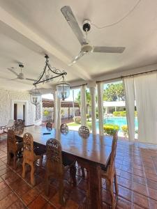 a dining room with a wooden table and chairs at Glamorous Getaway PM in Malindi