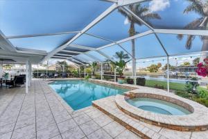 a large swimming pool with a glass roof at GRH14784 - Charlotte County - 4 Bed 2 Baths House in Punta Gorda Isles