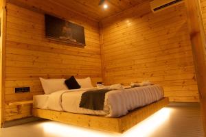 a bedroom with a bed in a wooden room at Tranquillo By The Beach, Candolim in Candolim +36 photos