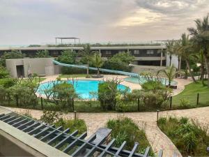 a resort with a swimming pool and a building at Pebble Beach 204 in Sibaya