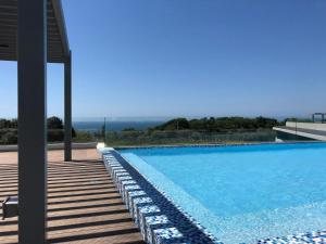 a swimming pool with a view of the ocean at Pebble Beach 204 in Sibaya