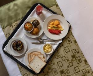 a tray of breakfast foods on a table at Biznotel by Pride Surat in Surat