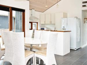 a kitchen with a white table and chairs at 8 person holiday home in Ulfborg-By Traum in Thorsminde