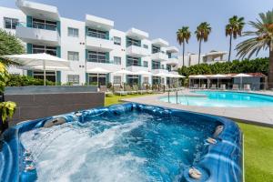 a pool at a resort with a water slide at Alsol Nara in Playa del Ingles