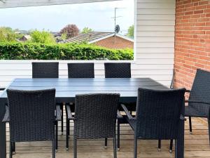 a blue table and chairs on a patio at 10 person holiday home in Roslev in Flovtrup +32 photos