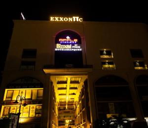 a building with a sign on top of it at night at Biznotel by Pride Surat in Surat