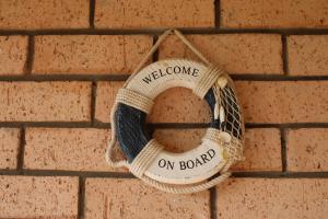 a welcome on board wreath on a brick wall at 28 Kabeljauws in Jeffreys Bay