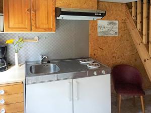 a small kitchen with a sink and a stove at 5 person holiday home in Tingsryd in Tingsryd