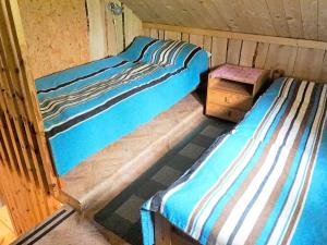 a room with two beds and a table in it at 5 person holiday home in Tingsryd in Tingsryd