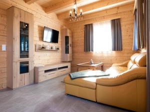 a living room with a couch and a window at Chalet in Koralpe with Panoramic Views in Elsenbrunn
