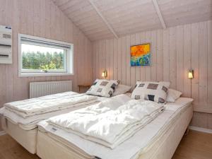 two large beds in a room with a window at 4 star holiday home in Hovborg in Hovborg