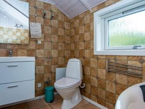 a bathroom with a toilet and a window at 4 star holiday home in Hovborg in Hovborg +29 photos