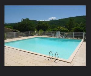 a large swimming pool with a chair in front of it at Mazet l'olivier 2 in Saint-Martin-de-Brômes