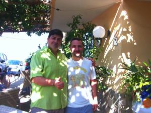 two men are standing next to each other at Locanda Degli Agrumi in Conca dei Marini