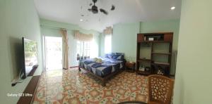 a bedroom with a bed and a tv in it at Cozy Apartment Kitchen 1 in Ko Lanta