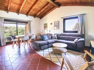a living room with a couch and a table at Villa Blu splendida villa con piscina - Stintino Sardegna in Cuile Pazzoni