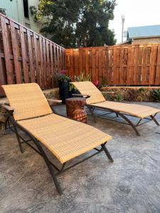 three chairs sitting on a patio next to a fence at Holualoa Gardens 204 in Kailua-Kona +5 photos