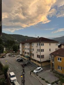 a city with cars parked in a parking lot at BPMNEdailyrent in Bijelo Polje