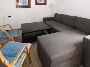 a living room with a couch and a chair at 6 person holiday home in Hadsund in Hadsund