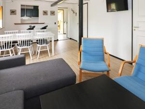 a living room with a couch and chairs and a table at 6 person holiday home in Hadsund in Hadsund