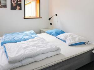 two beds sitting next to each other in a bedroom at 6 person holiday home in Hadsund in Hadsund