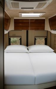 a bedroom with two beds in a train car at RWay The Moving Hotel by Theo in Budapest