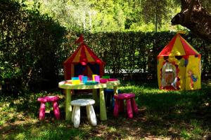 a pretend play table and stools in the grass at Evridiki's Villas in Agios Nikitas