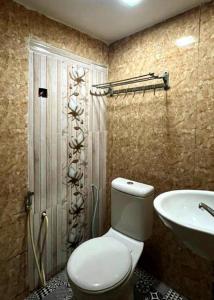 a bathroom with a toilet and a sink at Hartamas Business Hotel in Kuala Lumpur