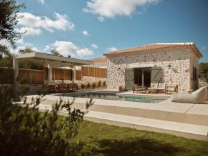a house with a swimming pool and a patio at Conte Maris V in Tragaki
