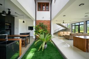 a living room with a green flooring in a house at Polaris- Kurunegala in Kurunegala