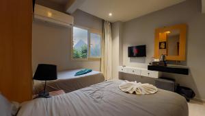 a hotel room with two beds and a window at Nut Pyramids Hotel in Cairo