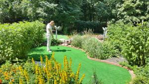 a man is playing golf in a garden at Oksana Hotel in Moscow