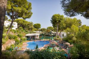 a large swimming pool in a resort with trees at Sunset Studio Mijas Costa in Sitio de Calahonda