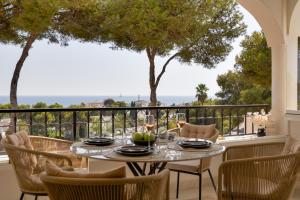 a dining room with a table and chairs on a balcony at Sunset Studio Mijas Costa in Sitio de Calahonda