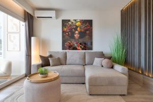 a living room with a couch and a painting at Sunset Studio Mijas Costa in Sitio de Calahonda +25 photos