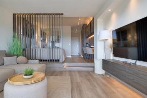 a living room with a couch and a table at Sunset Studio Mijas Costa in Sitio de Calahonda