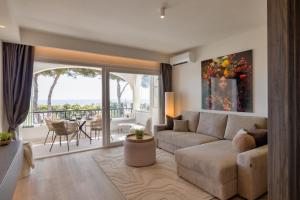 a living room with a couch and a balcony at Sunset Studio Mijas Costa in Sitio de Calahonda