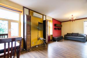 a living room filled with furniture and a tv at LEOGRAND Apartments on Virmenska 2 in Lviv