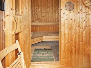 a wooden room with a sauna with a bench at 6 person holiday home in Sävsjö in Nykulla