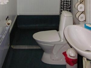 a bathroom with a white toilet and a sink at 6 person holiday home in Sävsjö in Nykulla +10 photos