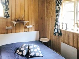 a bedroom with a blue bed with two pillows at 6 person holiday home in Sävsjö in Nykulla