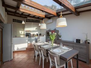 a kitchen and dining room with a table and chairs at Villa in Cortona with Private Pool in Magione