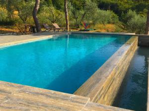 a swimming pool with blue water in a yard at Villa in Cortona with Private Pool in Magione