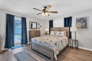 a bedroom with a bed and a ceiling fan at GRH14403 - Charlotte Harbor Area - 2 Bed 2 Baths Villa in Murdock