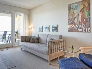 a living room with a couch and a glass table at Scenic Seaside Retreat in Sandkas-By Traum in Allinge