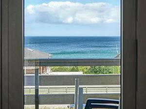a view of the ocean from a window at Scenic Seaside Retreat in Sandkas-By Traum in Allinge