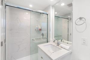 a white bathroom with a sink and a shower at Callister BNB in Vancouver +20 photos